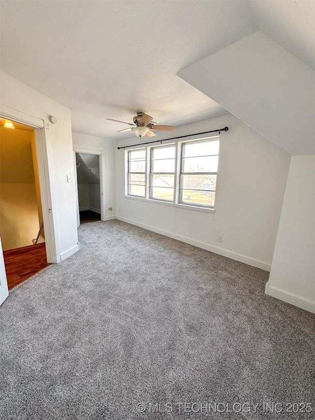 additional living space with carpet flooring, vaulted ceiling, and ceiling fan