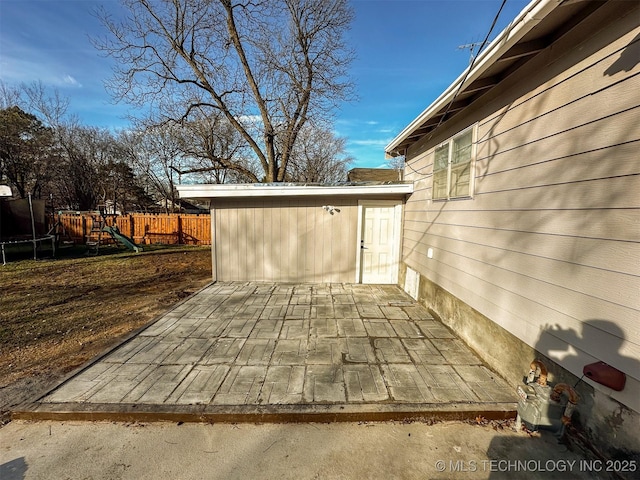 view of patio featuring a playground, a storage unit, and a trampoline