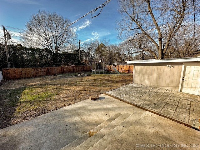 view of yard featuring a patio and a trampoline