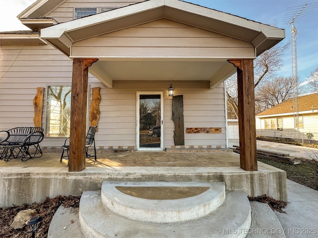 view of exterior entry with covered porch