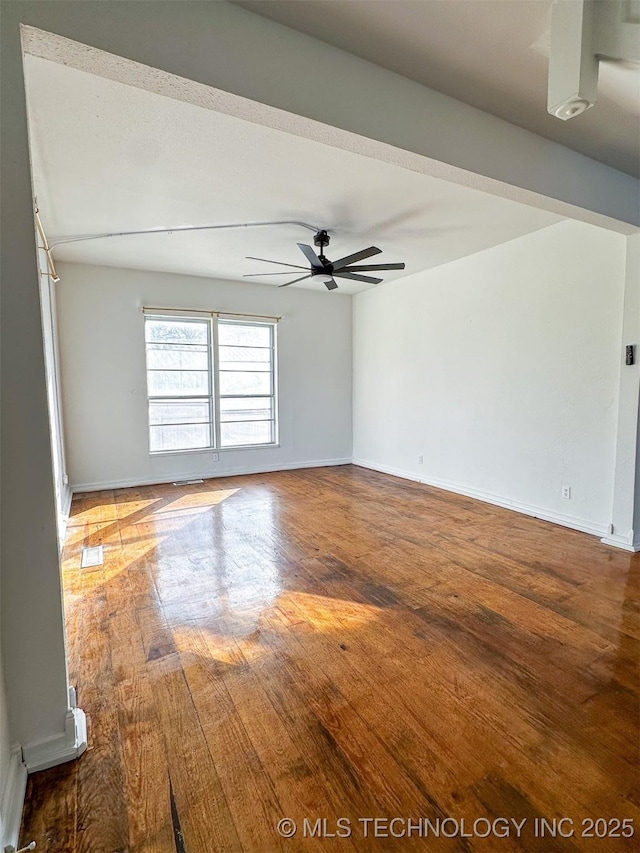 spare room with wood-type flooring and ceiling fan