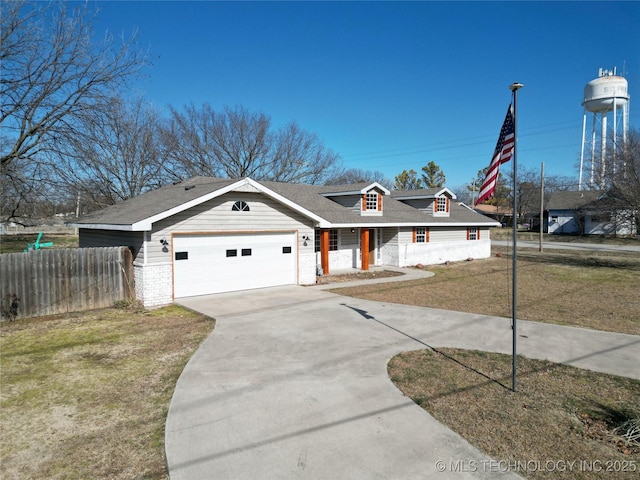 view of front of property featuring a garage and a front lawn