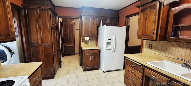 kitchen featuring white fridge with ice dispenser, sink, backsplash, stove, and light tile patterned flooring