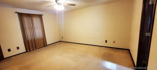 carpeted empty room with ceiling fan and a textured ceiling