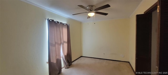 spare room featuring light carpet and ceiling fan