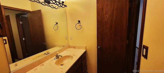 bathroom with vanity and a notable chandelier