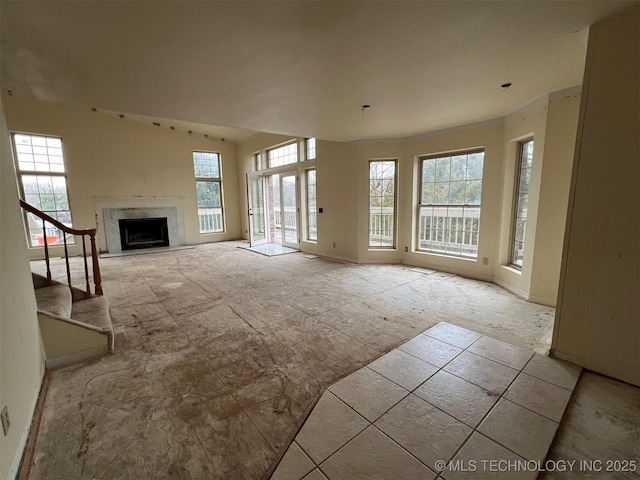 unfurnished living room featuring a premium fireplace