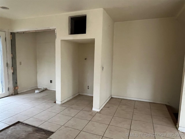 unfurnished room with light tile patterned floors