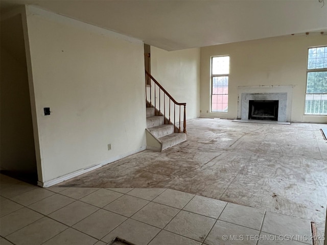 unfurnished living room with a high end fireplace