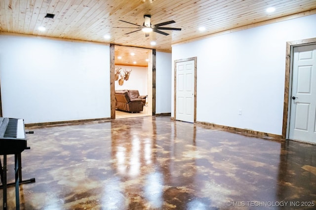 unfurnished room with wood ceiling, ceiling fan, and concrete floors