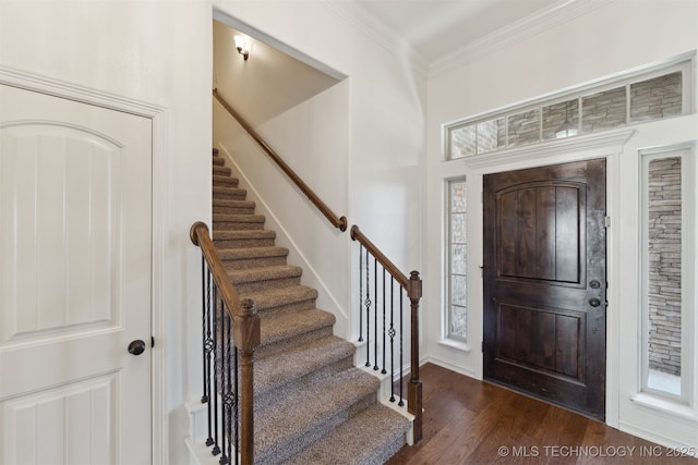 entrance foyer featuring dark hardwood / wood-style floors and crown molding