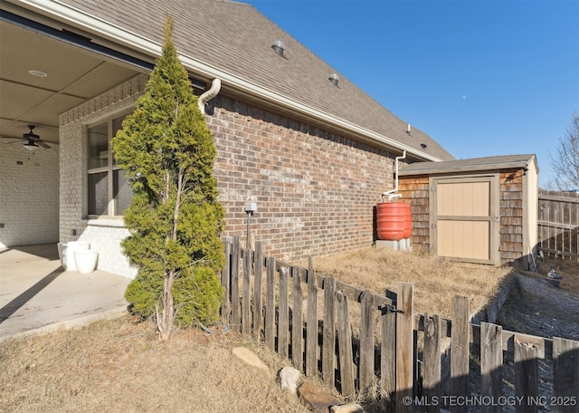 view of home's exterior featuring ceiling fan and a storage unit