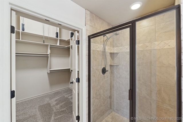 bathroom featuring a shower with door