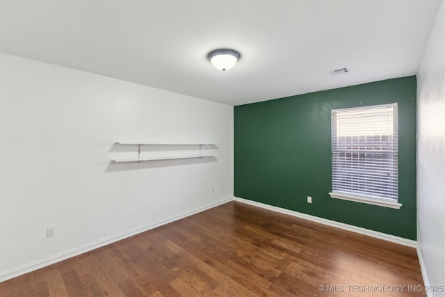 empty room with wood-type flooring