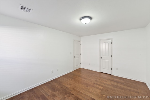 empty room with dark hardwood / wood-style floors