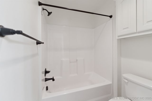 bathroom with bathtub / shower combination and toilet