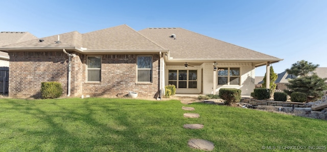 back of house featuring a lawn and ceiling fan