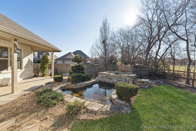 view of yard with a fenced in pool