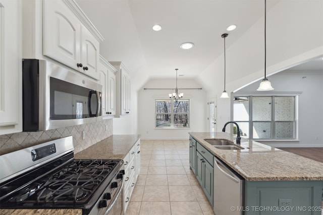 kitchen featuring white cabinets, stainless steel appliances, and decorative light fixtures