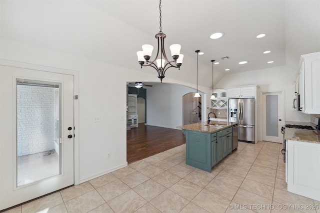 kitchen featuring pendant lighting, a center island with sink, sink, appliances with stainless steel finishes, and white cabinetry