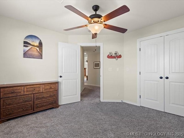 unfurnished bedroom featuring ceiling fan, a closet, and carpet