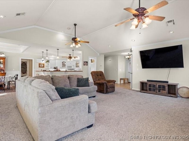 living room featuring ceiling fan, light colored carpet, vaulted ceiling, and ornamental molding