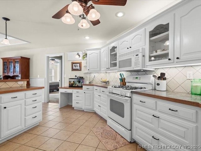 kitchen featuring decorative backsplash, white appliances, decorative light fixtures, white cabinets, and light tile patterned flooring