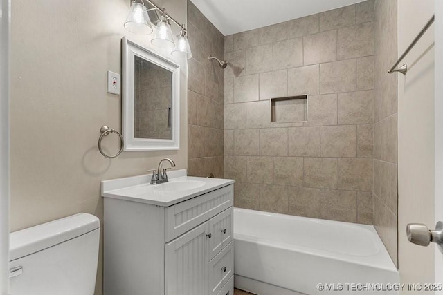 full bathroom with vanity, toilet, and tiled shower / bath