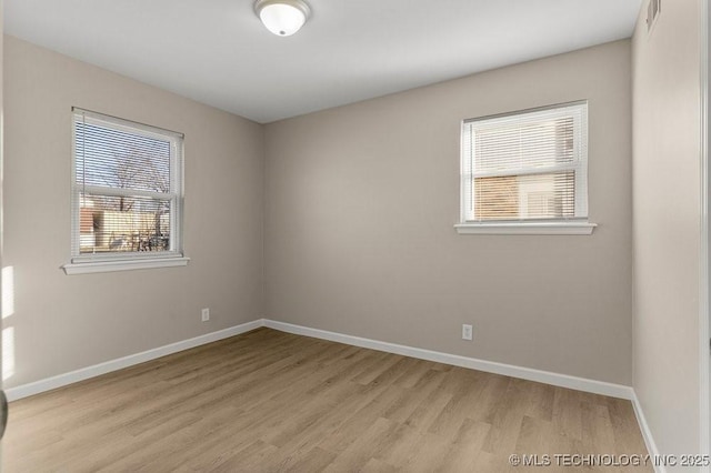 unfurnished room with light hardwood / wood-style floors