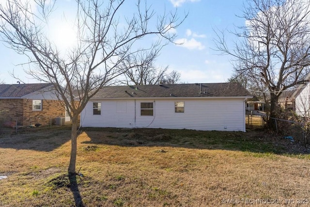 back of house with a lawn