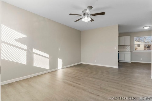 unfurnished living room with ceiling fan and light hardwood / wood-style floors