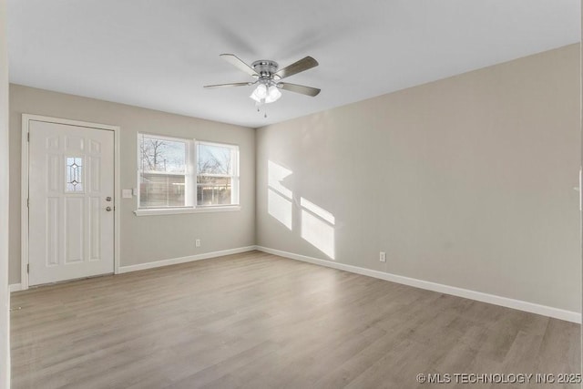 foyer with ceiling fan and light hardwood / wood-style floors