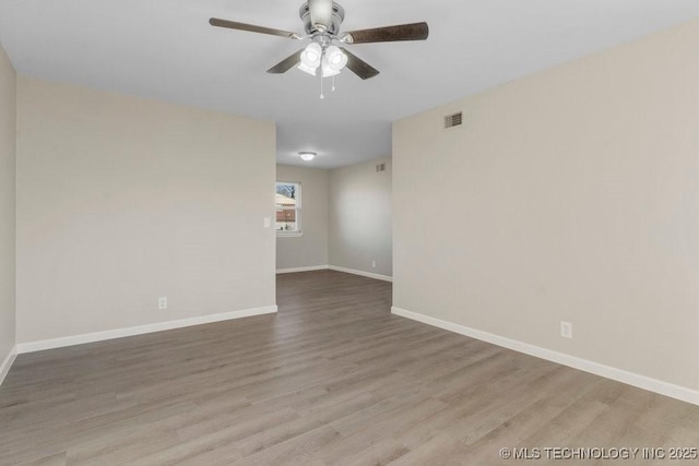 unfurnished room with hardwood / wood-style floors and ceiling fan