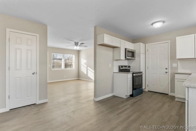 kitchen featuring light wood-type flooring, white cabinetry, and stainless steel appliances