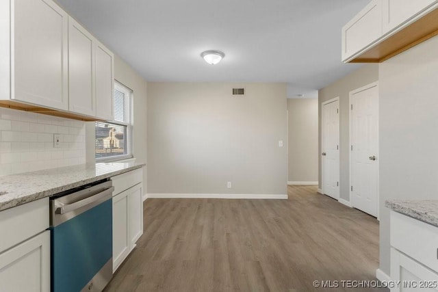 kitchen featuring white cabinetry, light stone counters, dishwasher, and light hardwood / wood-style floors