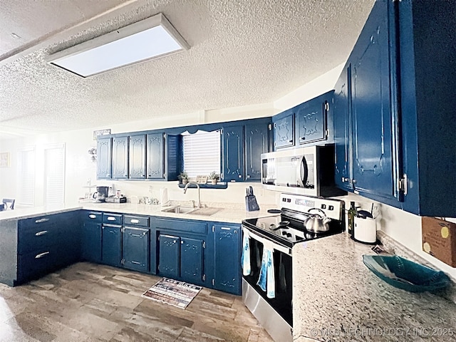 kitchen with light wood-type flooring, blue cabinets, and appliances with stainless steel finishes