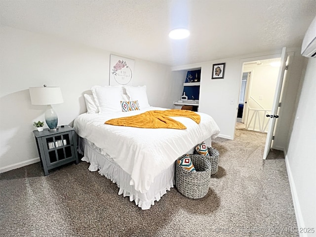 carpeted bedroom with a wall mounted AC and a textured ceiling