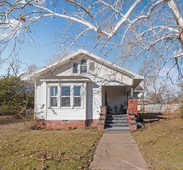 view of front of house with covered porch and a front yard