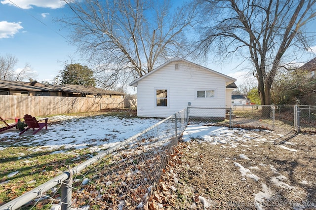 view of snow covered rear of property