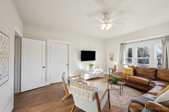 living room featuring dark hardwood / wood-style floors and ceiling fan