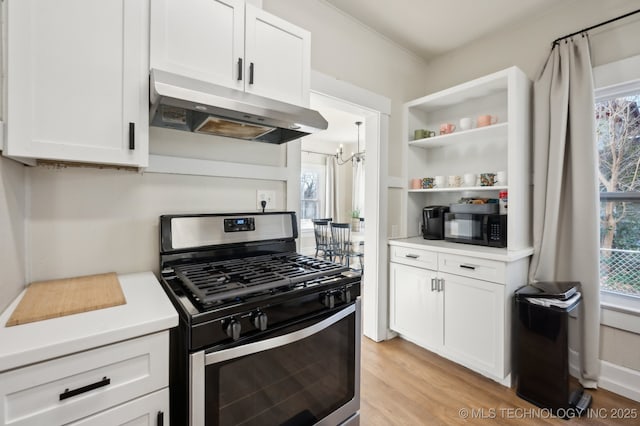 kitchen with white cabinetry, stainless steel range with gas cooktop, light hardwood / wood-style floors, and a notable chandelier