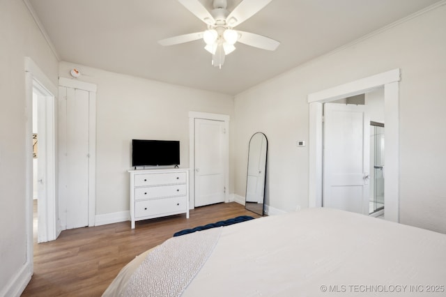 bedroom with ceiling fan, hardwood / wood-style floors, and crown molding