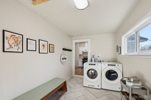 laundry area with washing machine and clothes dryer