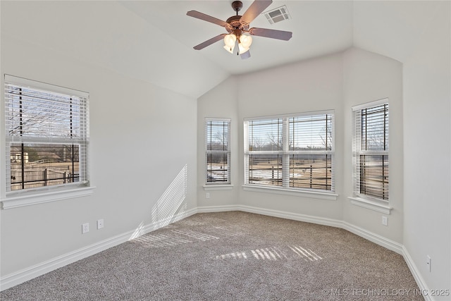 carpeted empty room featuring ceiling fan and vaulted ceiling