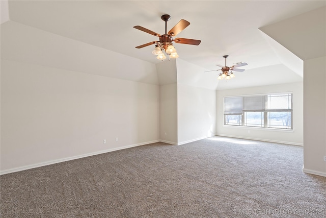 carpeted spare room featuring lofted ceiling and ceiling fan