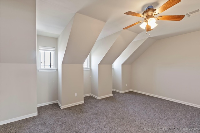 additional living space with vaulted ceiling, carpet floors, and ceiling fan