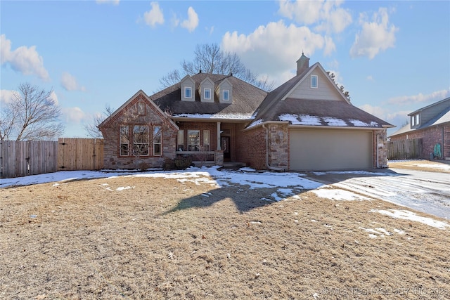 view of front of house featuring covered porch and a garage