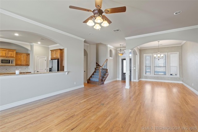 unfurnished living room featuring light hardwood / wood-style flooring, crown molding, and ceiling fan with notable chandelier