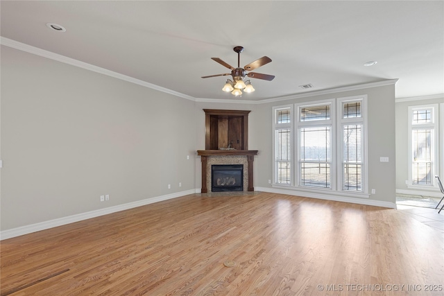 unfurnished living room with ornamental molding, ceiling fan, and light wood-type flooring