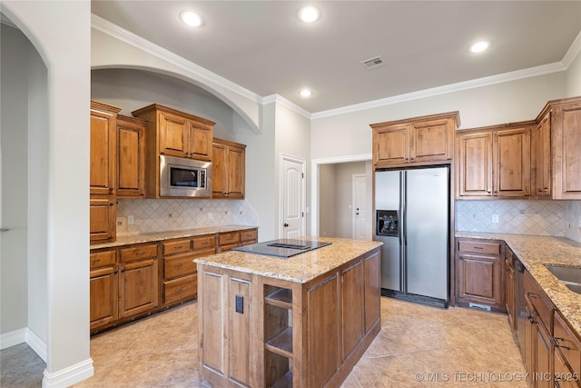 kitchen featuring tasteful backsplash, stainless steel appliances, ornamental molding, and a kitchen island